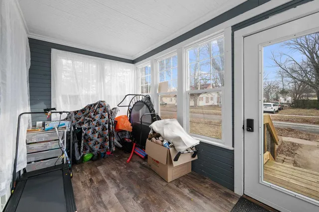 a bedroom with furniture and large window