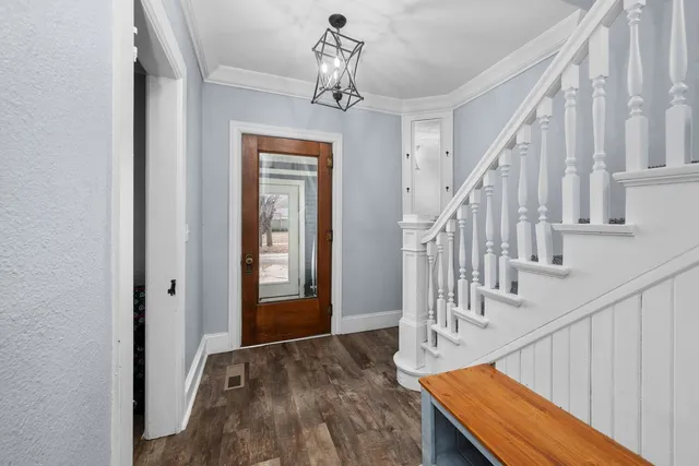 a view of entryway and hall with wooden floor