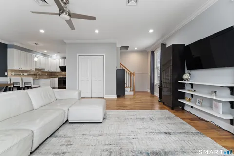a living room with furniture and kitchen view