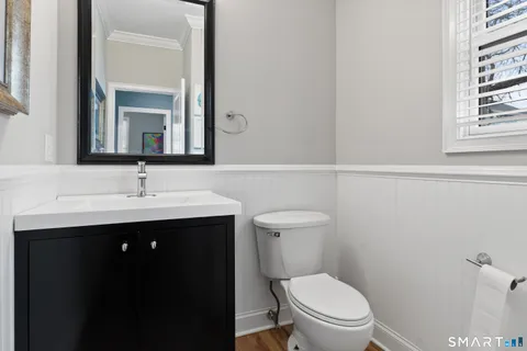 a bathroom with a sink vanity mirror and toilet