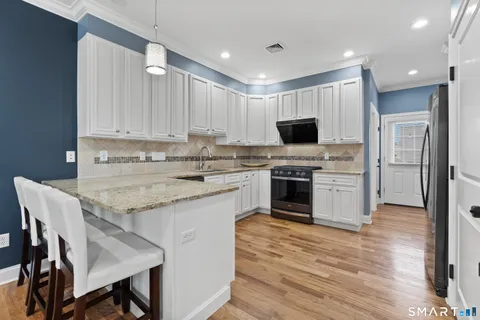 a kitchen with a stove a sink and a refrigerator