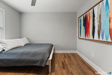 a bedroom with a bed and a book shelf