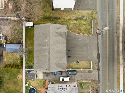 an aerial view of a residential houses with outdoor space