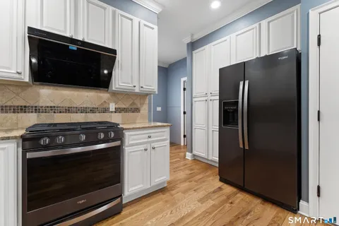 a kitchen with stainless steel appliances and wooden cabinets