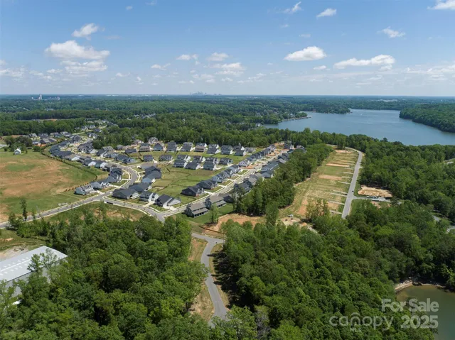 an aerial view of a house with a lake view