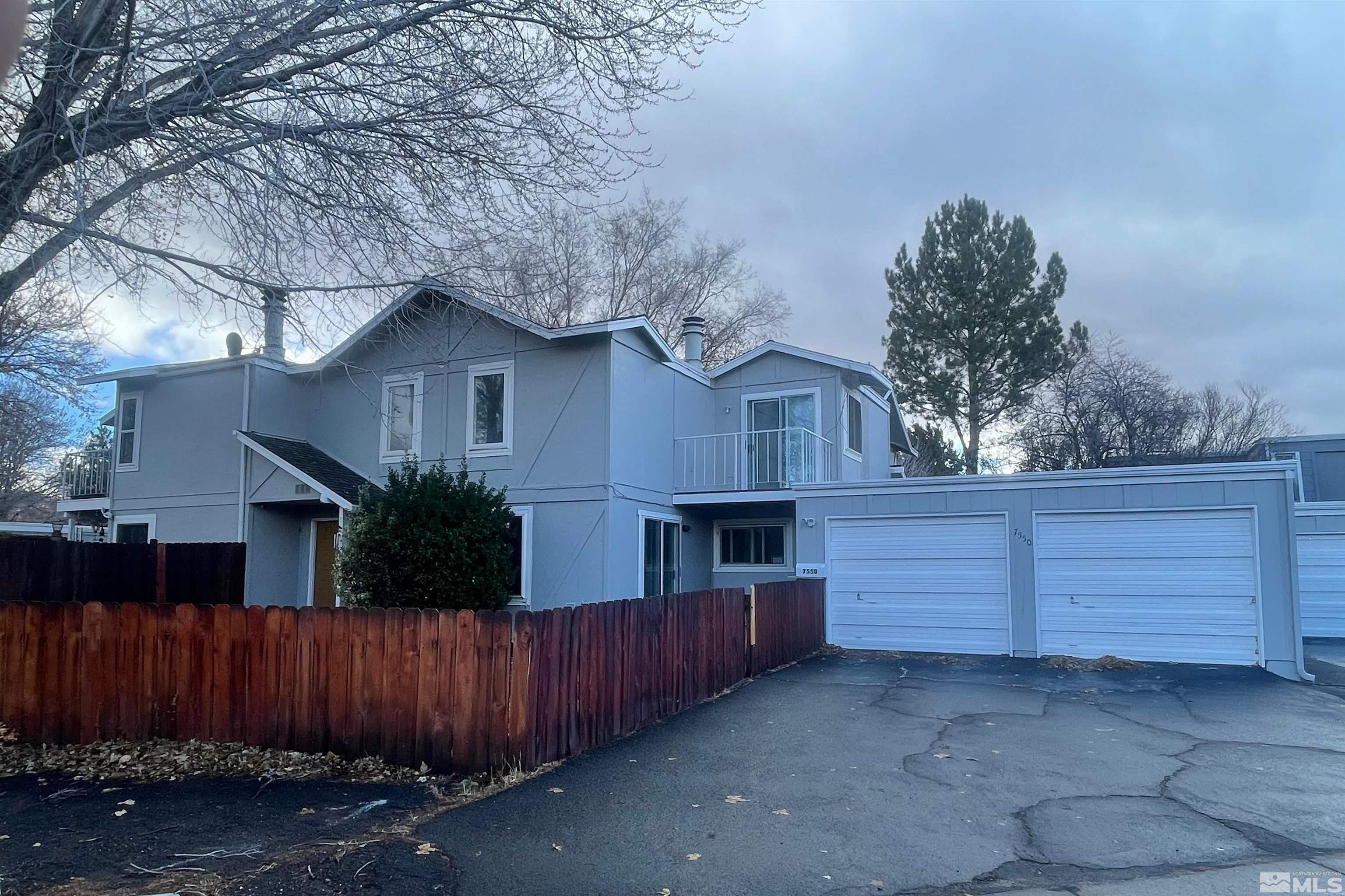 a view of house with outdoor space and potted plants