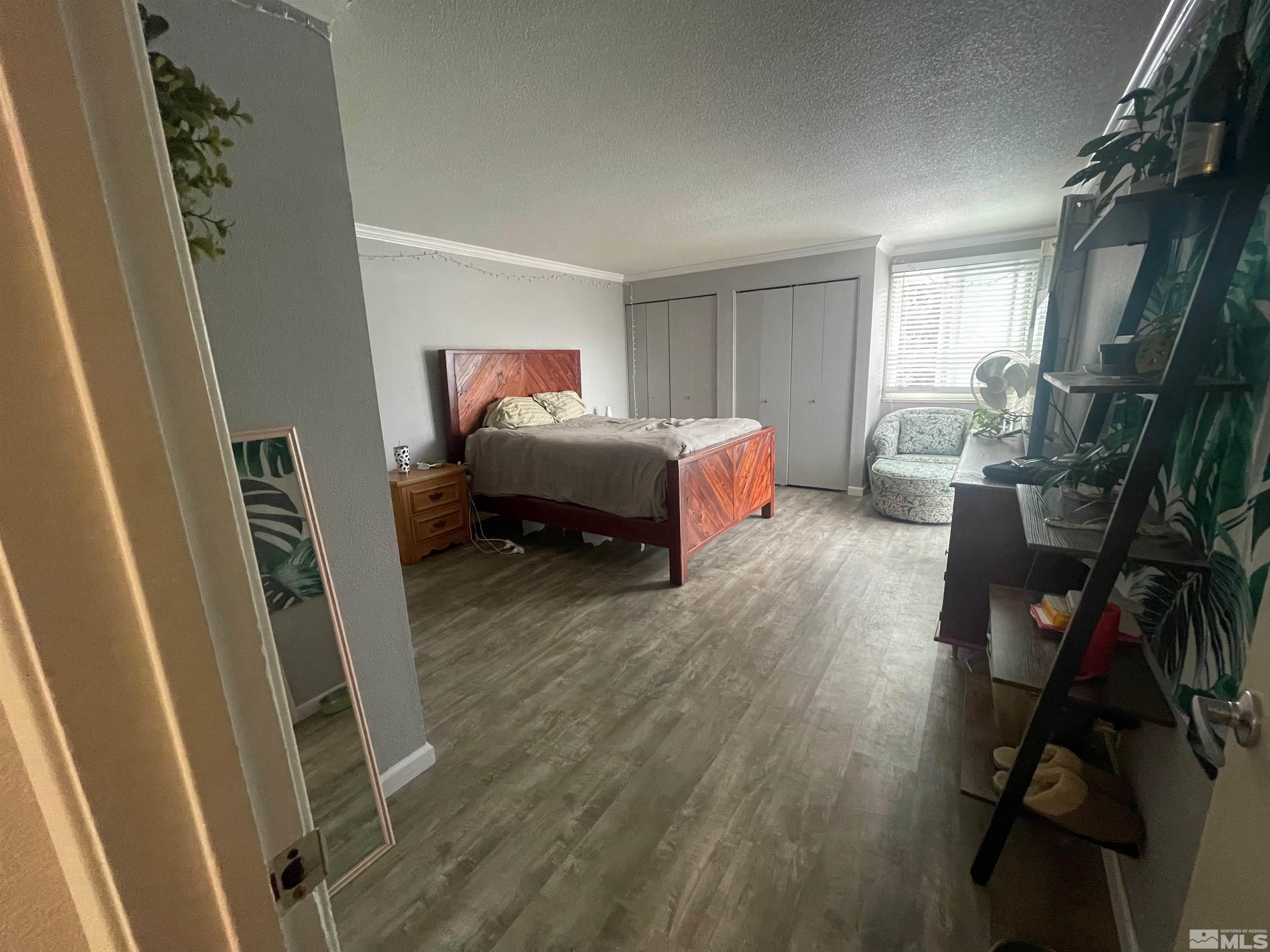 7550 Bluestone Drive Reno, NV 89511 - Photo 12 of 15 a spacious bedroom with a bed and a window