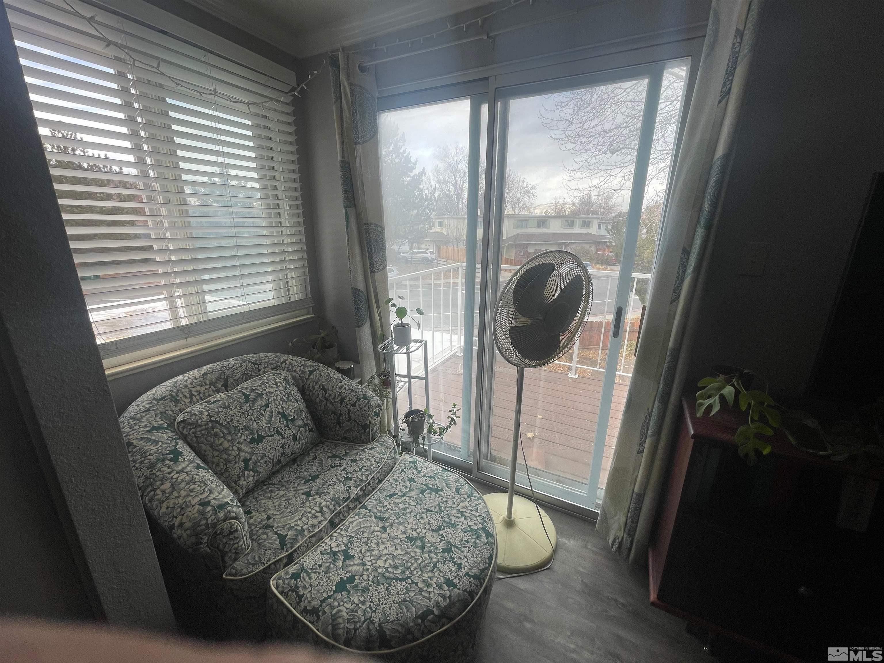 7550 Bluestone Drive Reno, NV 89511 - Photo 15 of 15 a living room with furniture and a floor to ceiling window