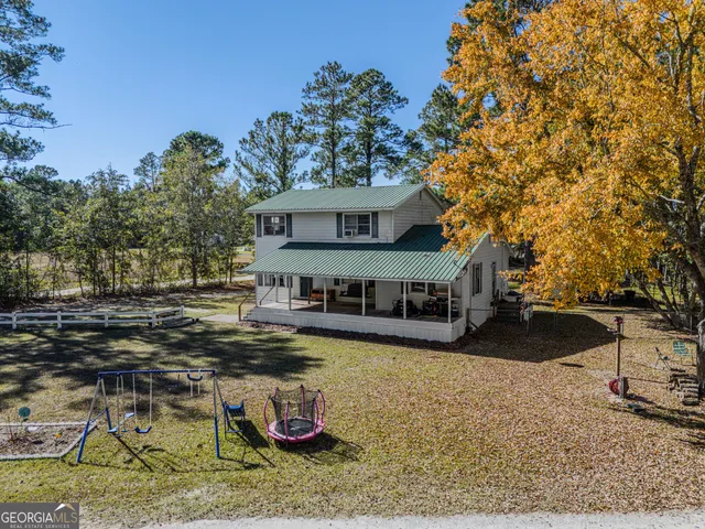 a view of a house with backyard porch and sitting area