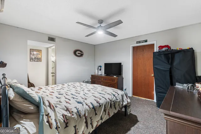 a view of a livingroom with furniture and a flat screen tv