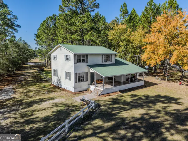 a view of a house with wooden fence