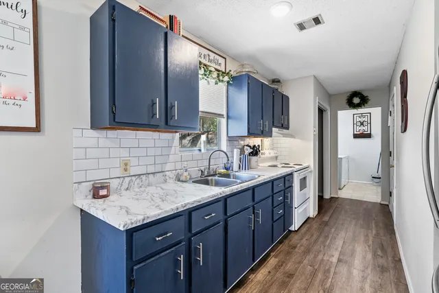 a bathroom with a granite countertop sink a mirror and a shower