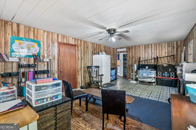a view of a house with backyard and sitting area