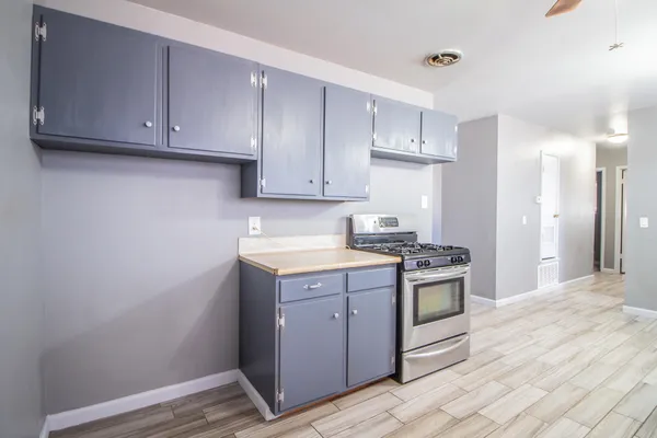 a kitchen with stainless steel appliances granite countertop a stove and a refrigerator