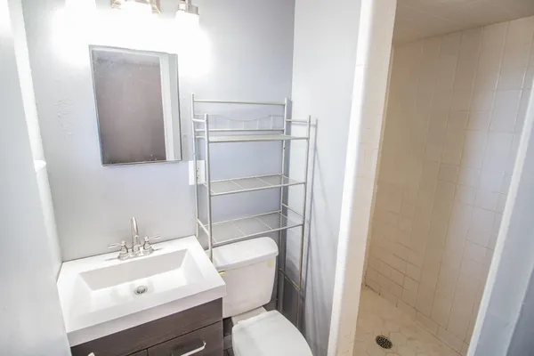 a bathroom with a sink toilet and shower