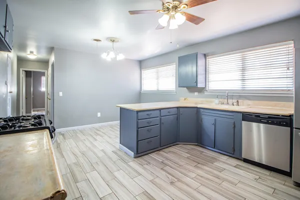 a kitchen with a stove a sink and a window