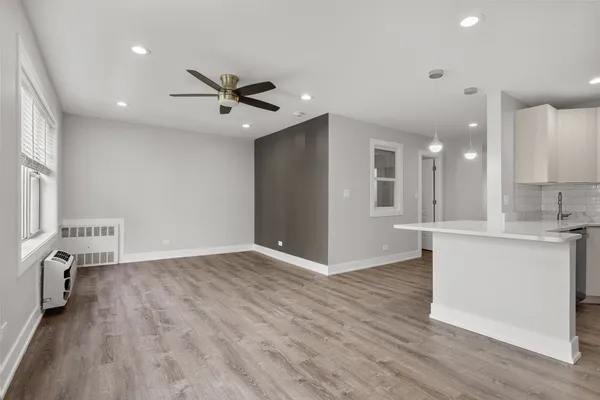 a view of kitchen with sink microwave and wooden floor