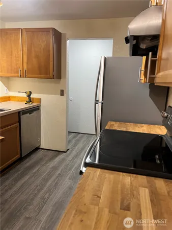 a kitchen with refrigerator and window