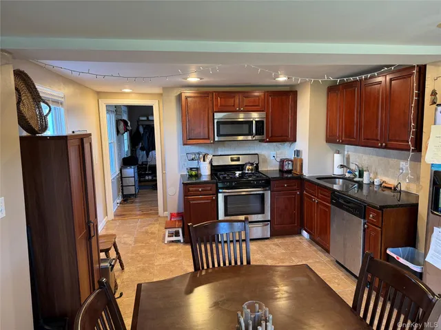 a living room with furniture a rug and a window