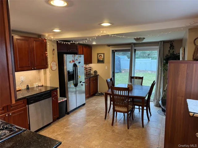 a view of a dining room with furniture and window