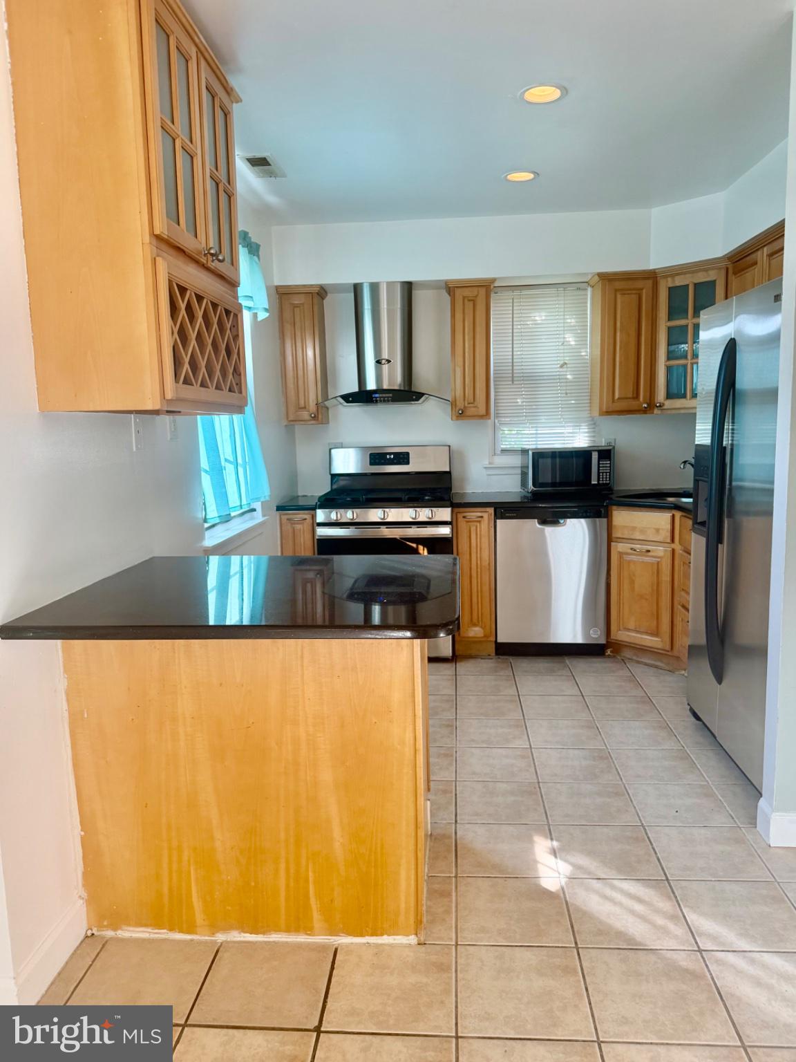 2091 Red Lion Road, Unit A Philadelphia, PA 19116 - Photo 2 of 5 a kitchen with stainless steel appliances granite countertop a refrigerator and stove
