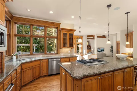 a kitchen with granite countertop a sink and a wooden floor