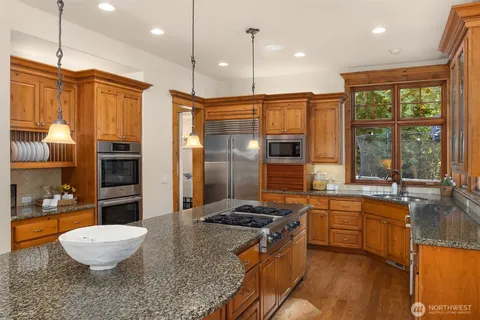 a kitchen with a stove a sink and a refrigerator