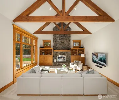 a living room with fireplace furniture and a window