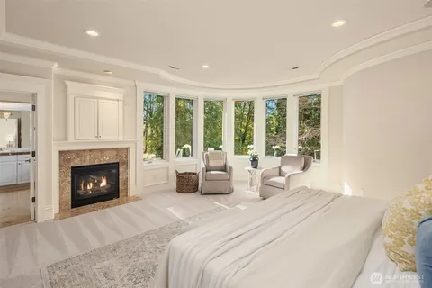a bedroom with a large bed and a fireplace