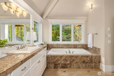 a spacious bathroom with sink and bathtub