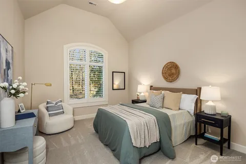 a bedroom with a bed and a couch