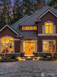 a view of a house with pool and sitting area