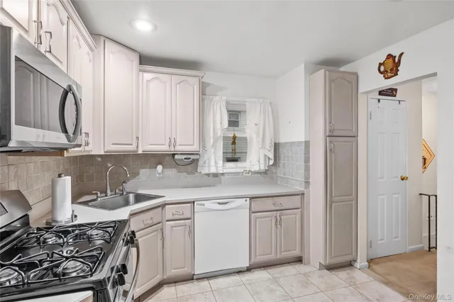 a kitchen with a sink stove and refrigerator