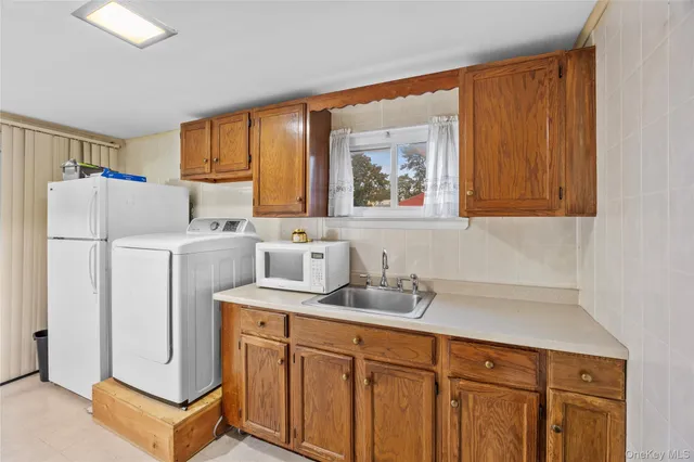 a kitchen with refrigerator cabinets and a sink