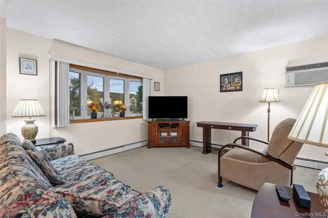 a bedroom with furniture and a flat screen tv