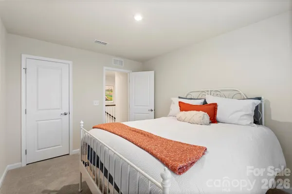a bedroom with a bed and a night stand