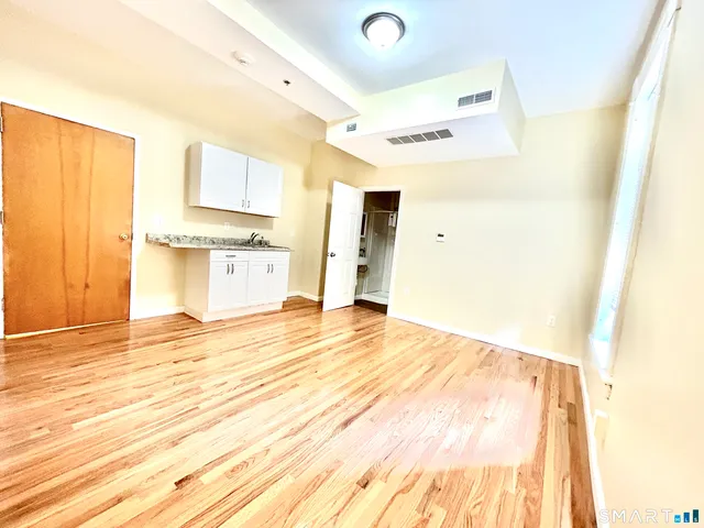 a bathroom with a sink mirror and a shower