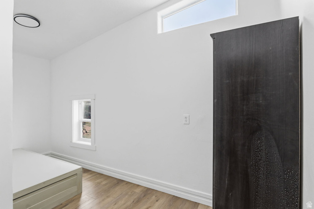 4270 River Road Oakley, UT 84055 - Photo 35 of 46 Minimalist interior featuring wood-finish flooring, a small framed window, and a high transom window providing ambient light
