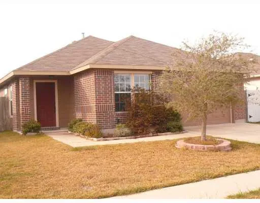 a view of a house with snow on the road