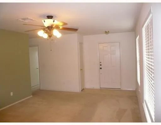 a view of a chandelier fan and closet in a room