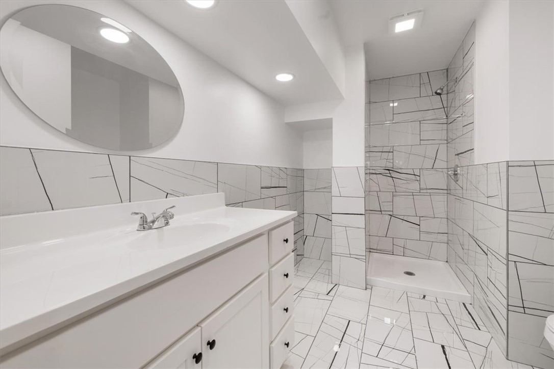629 Little Meadow Drive Riverside, OH 45404 - Photo 22 of 48 Bright and clean bathroom featuring a vanity, shower, and contemporary tile work.