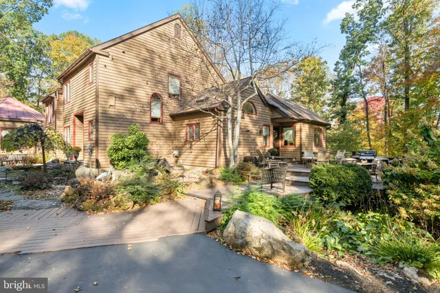 a view of a patio with table and chairs and potted plants with wooden floor and fence