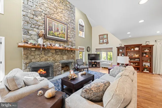 a kitchen with stainless steel appliances granite countertop a stove a refrigerator a oven a sink with a dining table and chairs