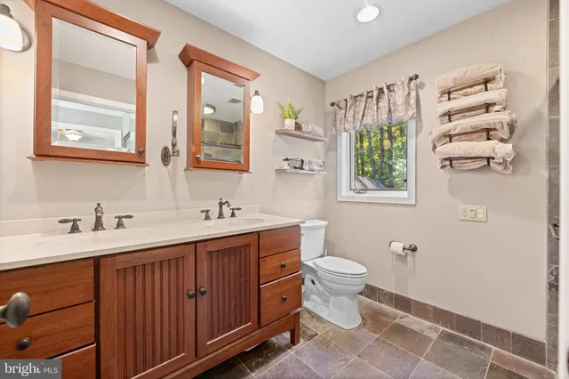 a white toilet sitting next to a bathroom sink
