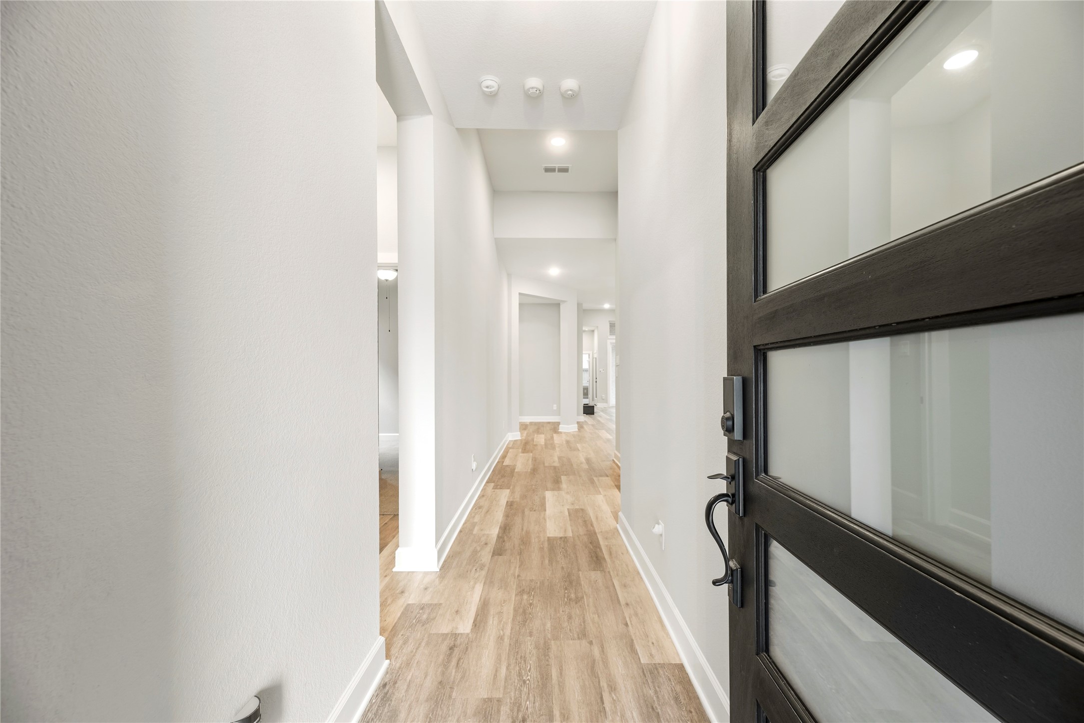 3438 Rich Radish Road Richmond, TX 77406 - Photo 2 of 25 The grand formal entry makes a sleek statement with soaring high ceilings, soft contemporary tones, and upgraded SPC engineered wood flooring in an elegant Urban Graphite finish that extends throughout the main living areas.