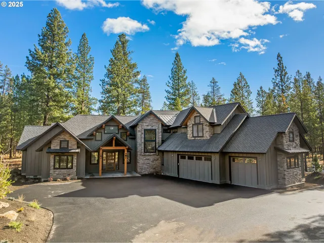 a view of a large house with a yard and large trees