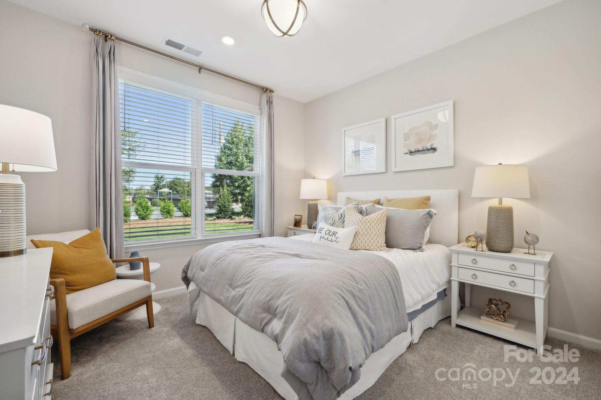 1414 Hubert Graham Way Tega Cay, SC 29708 - Photo 16 of 28 a bedroom with a bed and a couch
