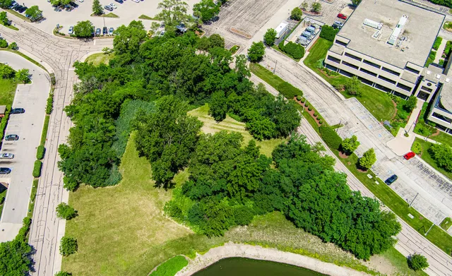 an aerial view of a residential houses with yard