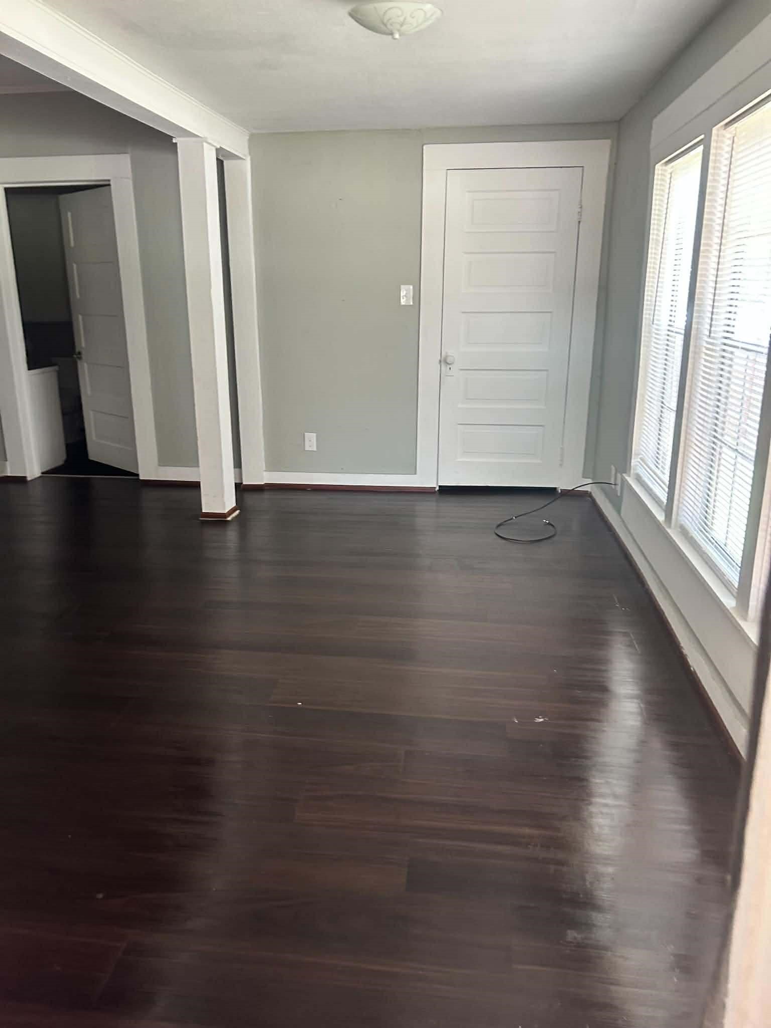 11 Smith Street Shepherd, TX 77371 - Photo 9 of 31 a view of an empty room with wooden floor and a window