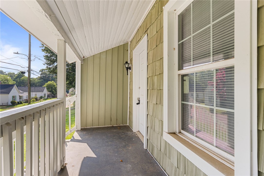 109 Farmer Street Anderson, SC 29621 - Photo 7 of 31 A welcoming covered porch with a refreshing outdoor setting awaits.